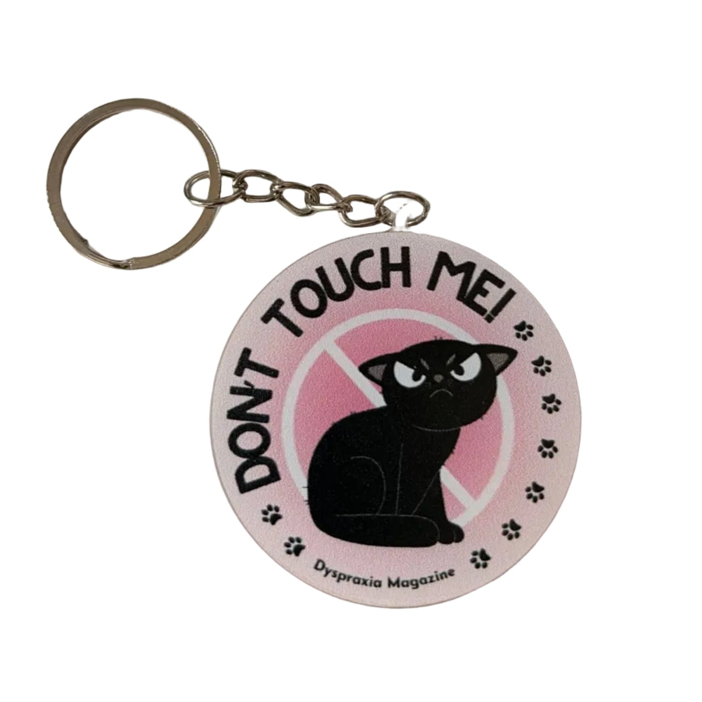 A round acrylic keychain featuring a black cat silhouette on a pink background with the text 'TOUCH ME! DON'T' and paw prints, attached to a silver metal key ring.