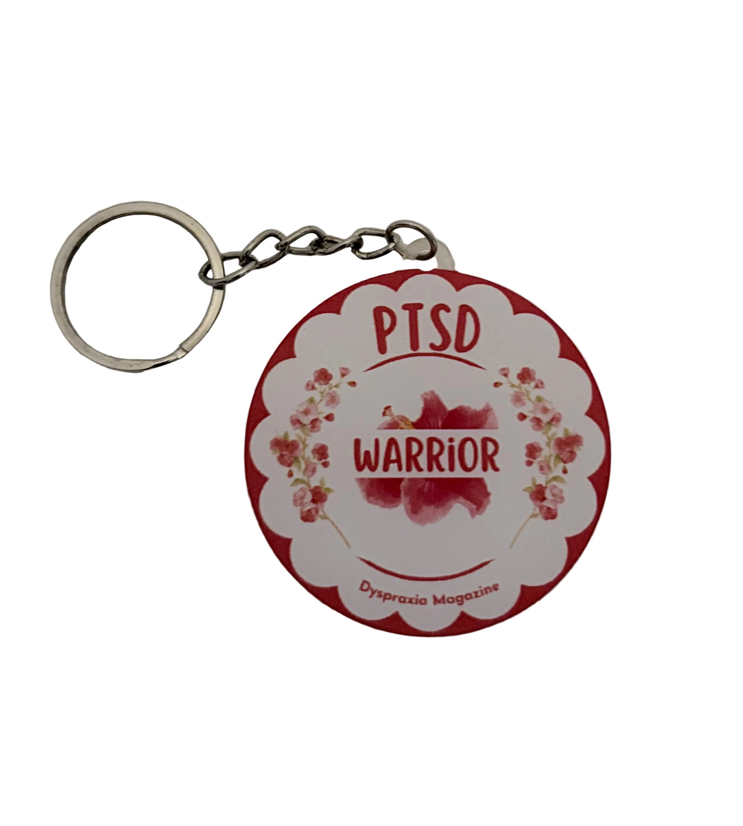 A circular keychain featuring a red and white scalloped design with the words 'PTSD WARRIOR' and small floral illustrations, attached to a silver metal split ring on a white textured background.