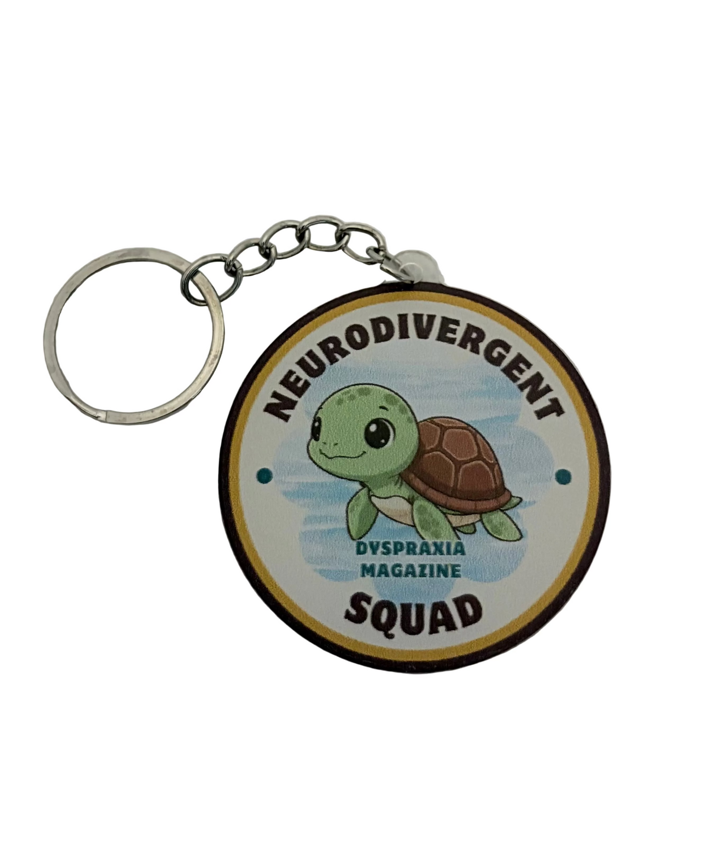 A round keychain featuring a cartoon green sea turtle on a light blue background, with the text 'NEURODIVERGENT SQUAD' at the bottom. The keychain has a silver metal split ring and chain, and is photographed on a white textured background.