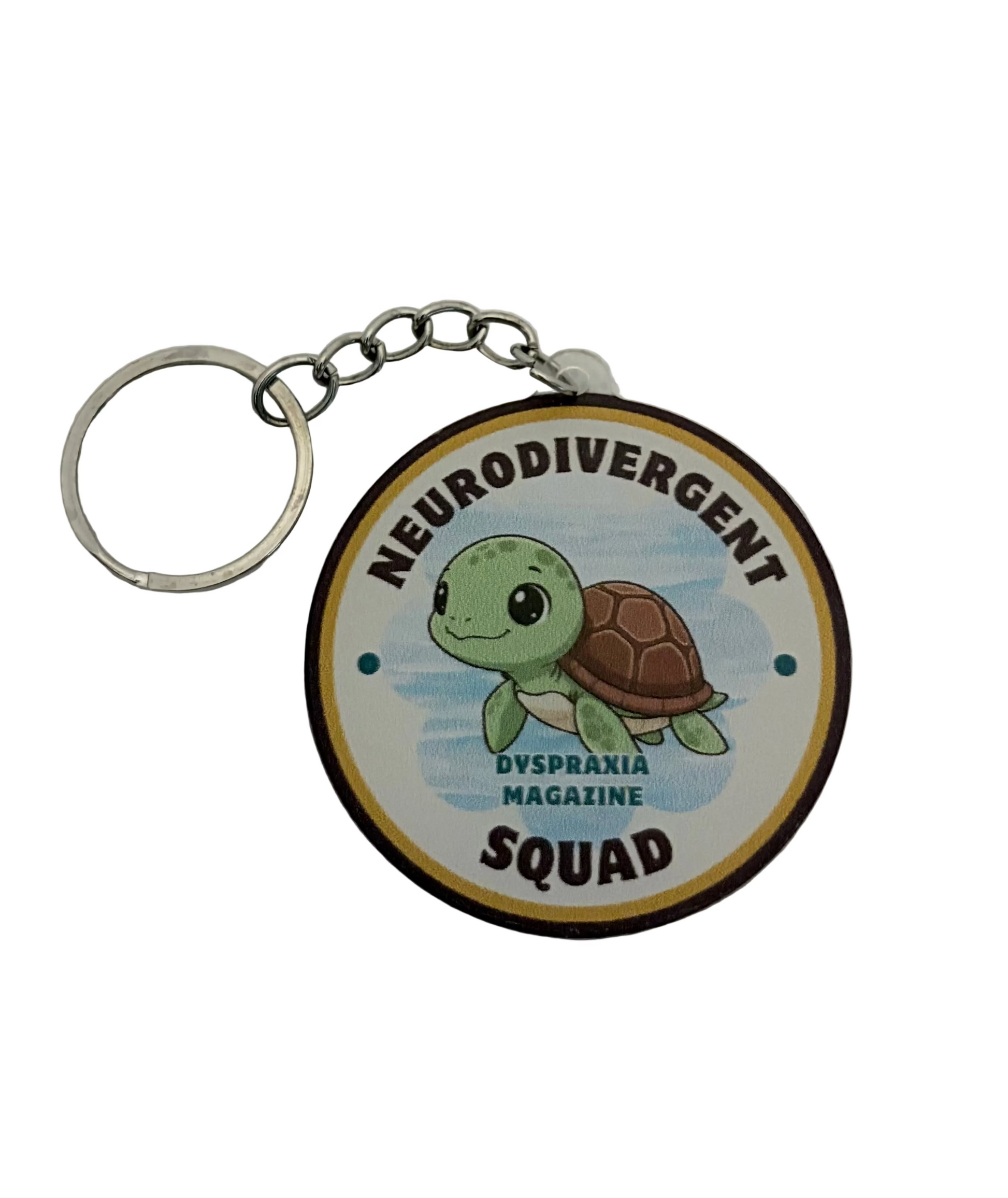 A round keychain featuring a cartoon green sea turtle on a light blue background, with the text 'NEURODIVERGENT SQUAD' at the bottom. The keychain has a silver metal split ring and chain, and is photographed on a white textured background.